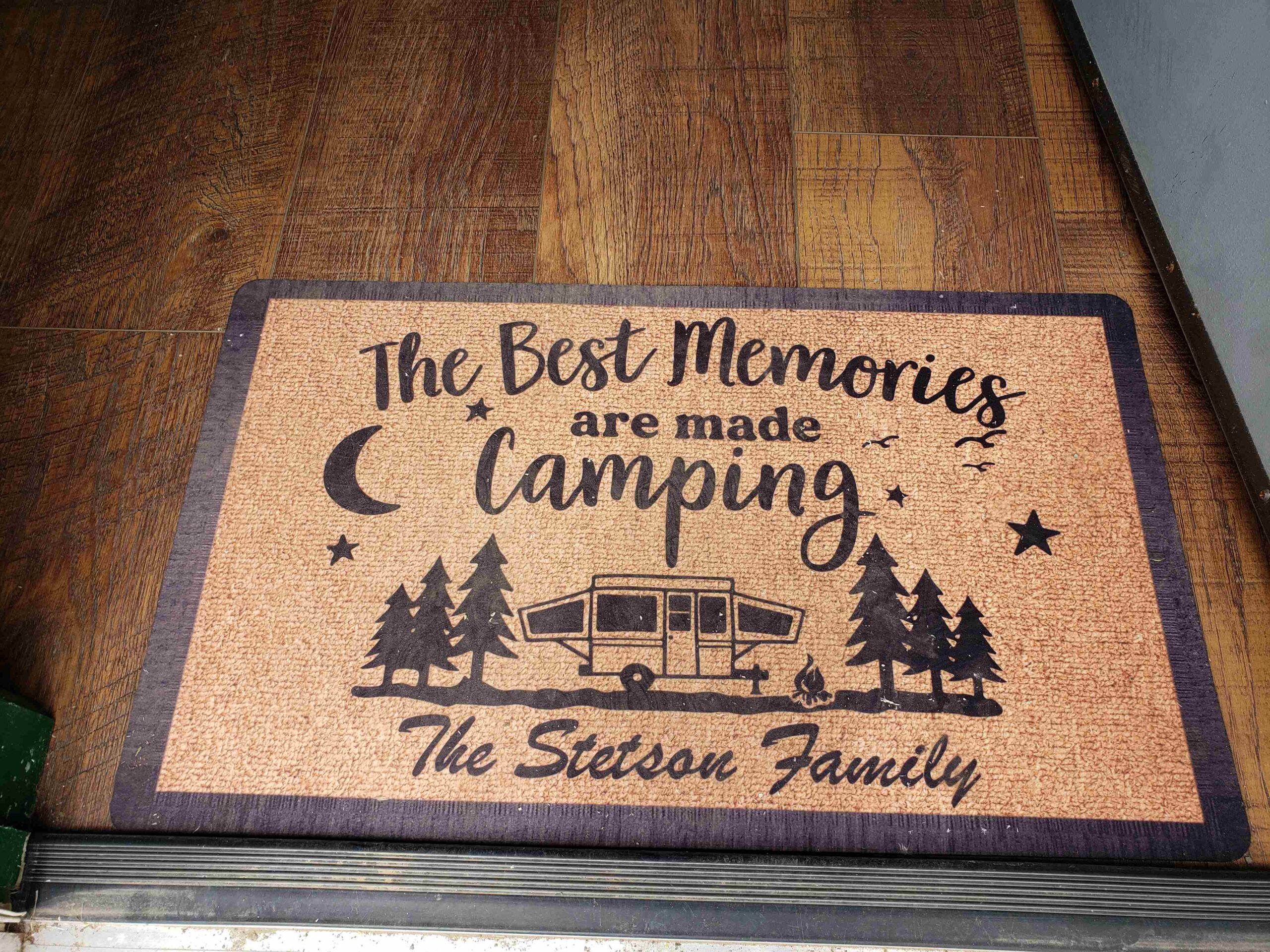 A doormat reads, "The best memories are made camping – The Stetson Family," with images of trees, a camper, a campfire, and stars.